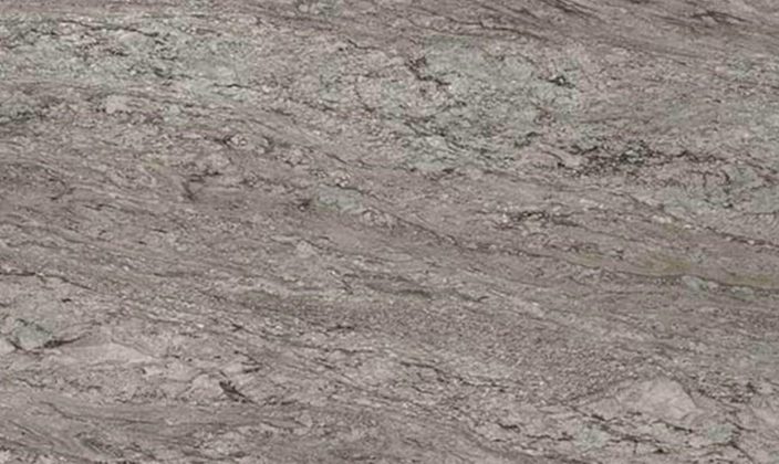 Close-up view of a textured grey stone surface with streaks and patches of lighter and darker shades.