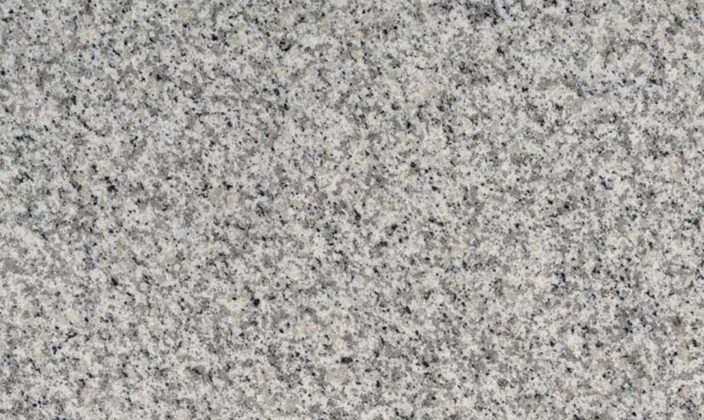 Close-up view of a grey granite surface with a speckled pattern of black, white, and grey minerals.