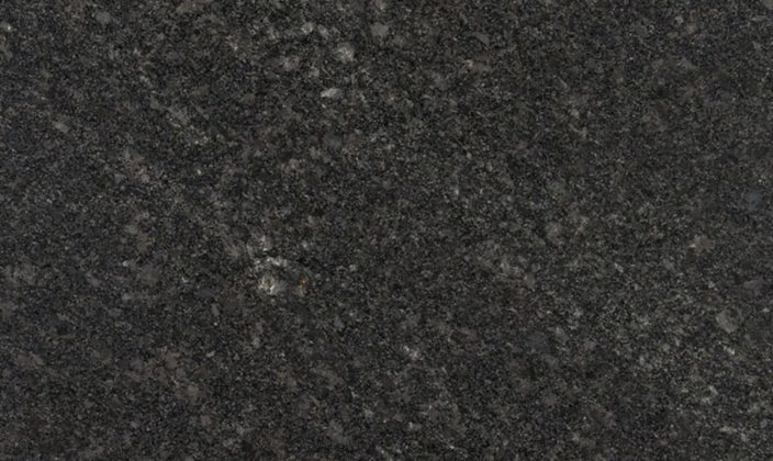 Close-up of a dark gray, speckled granite surface with subtle variations in texture and lighter flecks throughout.